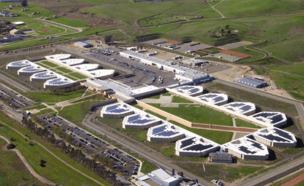 A high aerial photo of  the Santa Rita Jail, Dublin, CA...a massive site with identical geometrical housing units grouped symmetrically around exercise yards